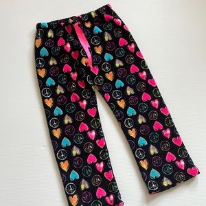 Just Dream it black pajama pants with hearts, & peace signs. Girls size large